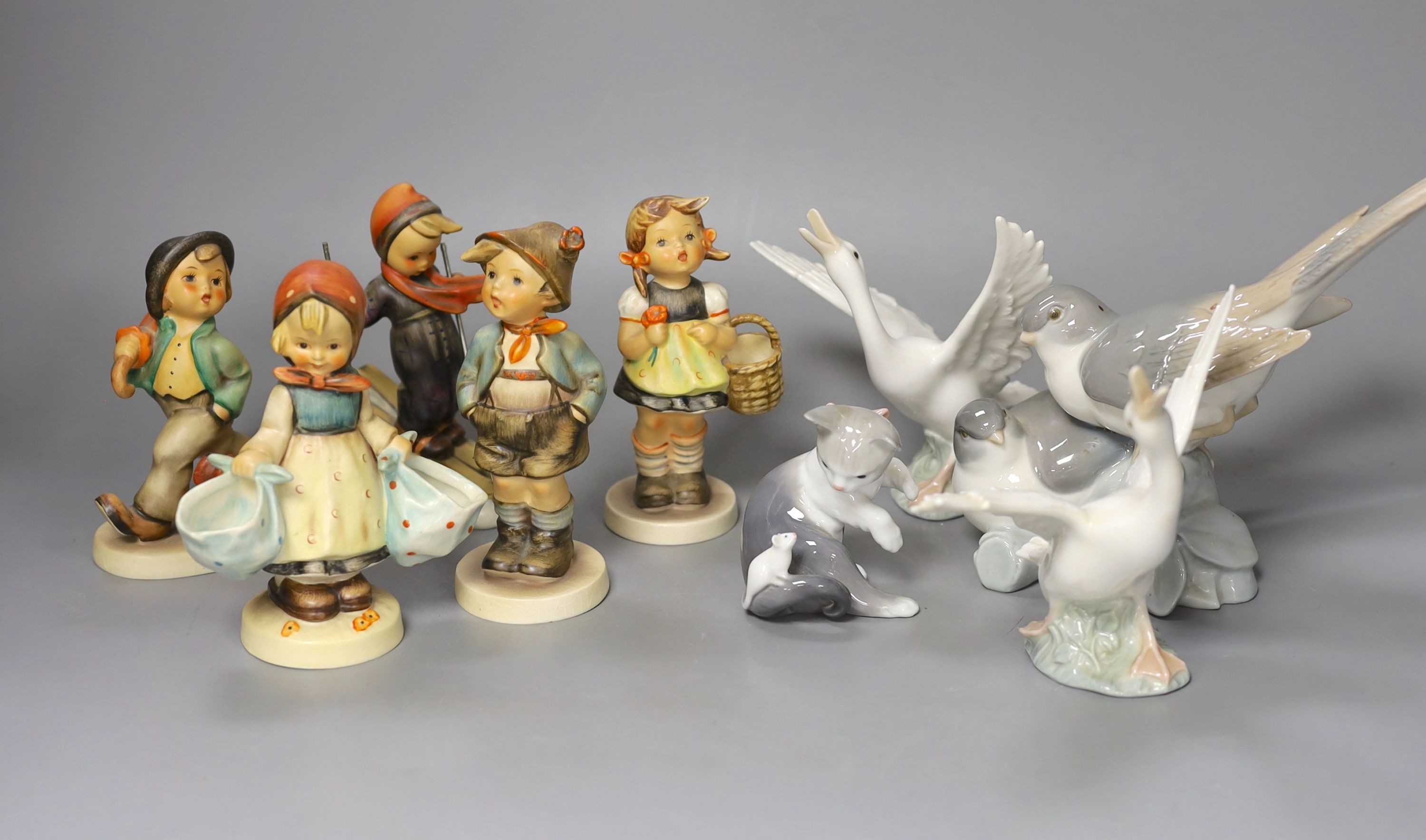 Five Hummel earthenware figures, tallest 14cm., and four Lladro animal models